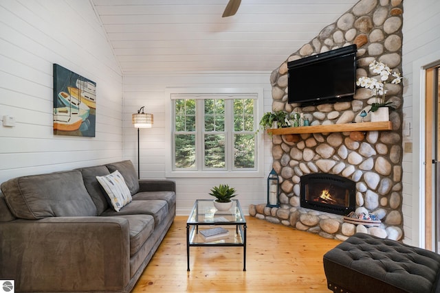 421 S Shabwasung St, Northport, MI 49670 - living room featuring vaulted ceiling, a fireplace, hardwood / wood-style floors, and a ceiling fan