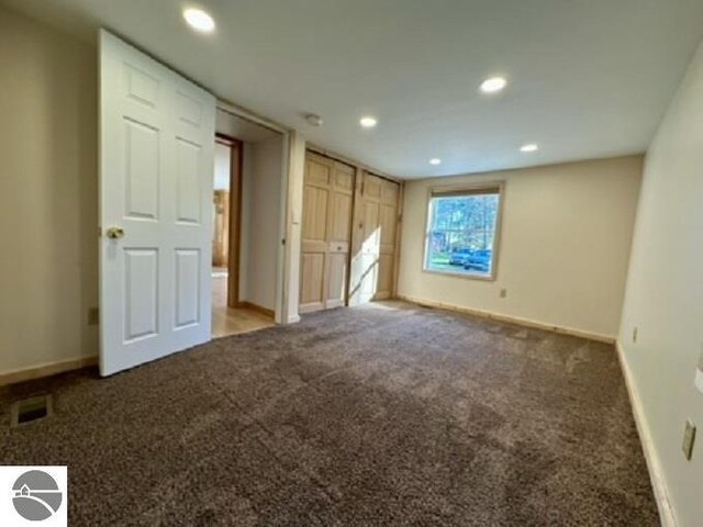 unfurnished bedroom with carpet, baseboards, and recessed lighting