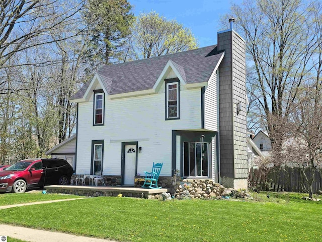 117 S Gladwin St, Lake City, MI 49651 - view of front facade featuring a shingled roof and a chimney