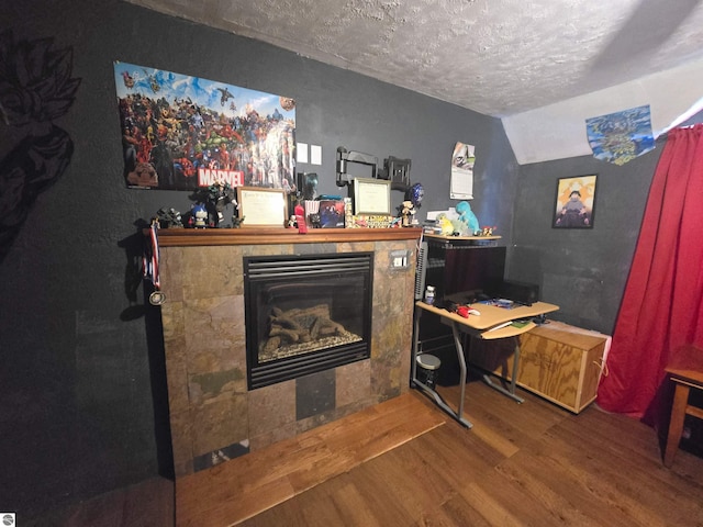 117 S Gladwin St, Lake City, MI 49651 - office featuring wood finished floors, a textured ceiling, a fireplace, and lofted ceiling