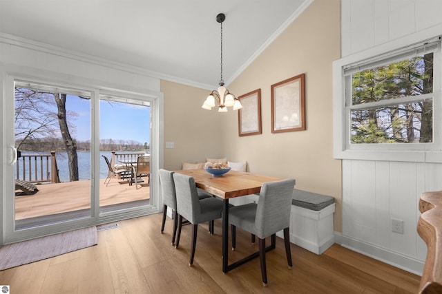1750 S Schneider St, Lake City, MI 49651 - dining space featuring vaulted ceiling, crown molding, a chandelier, wood finished floors, and plenty of natural light