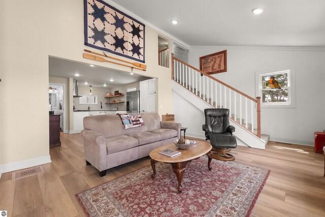 1750 S Schneider St, Lake City, MI 49651 - living room with light wood-style flooring, stairs, ornamental molding, baseboards, and recessed lighting