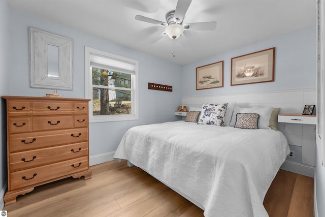 1750 S Schneider St, Lake City, MI 49651 - bedroom with light wood finished floors, baseboards, and a ceiling fan
