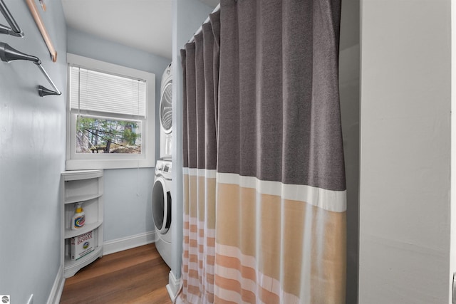 1750 S Schneider St, Lake City, MI 49651 - laundry area featuring estacked washer and dryer, baseboards, and dark wood finished floors