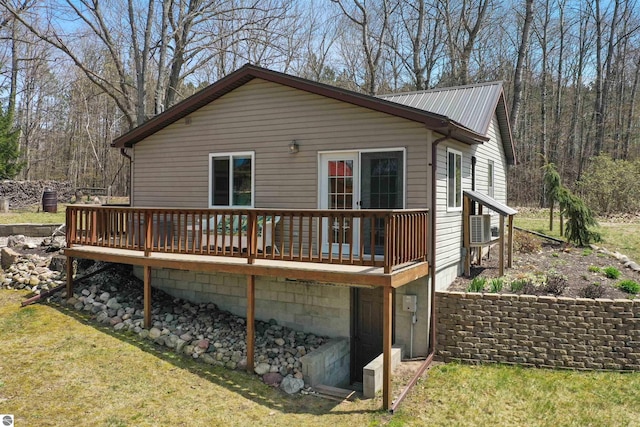 1750 S Schneider St, Lake City, MI 49651 - back of property with a deck, a yard, and metal roof