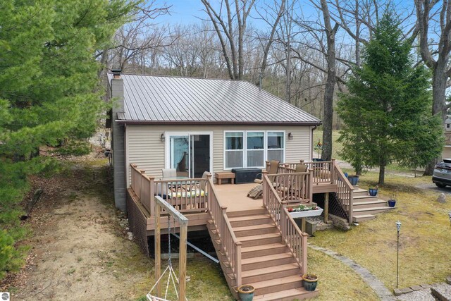 1750 S Schneider St, Lake City, MI 49651 - rear view of property featuring stairs, metal roof, a deck, and a chimney