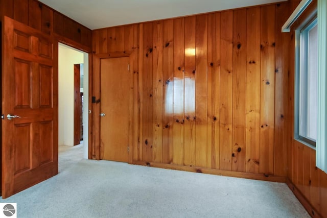 12225 SW Torch Lake Dr SW, Rapid City, MI 49676 - carpeted spare room featuring wooden walls