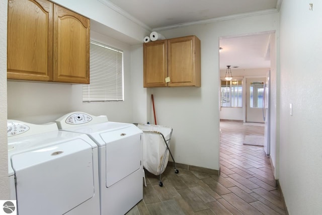 12225 SW Torch Lake Dr SW, Rapid City, MI 49676 - laundry room featuring washer and dryer, cabinet space, crown molding, and baseboards