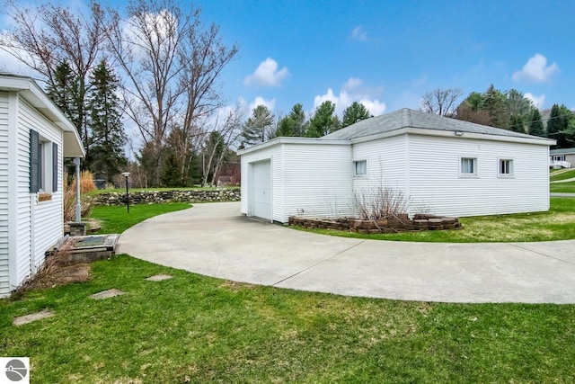 12225 SW Torch Lake Dr SW, Rapid City, MI 49676 - view of property exterior featuring a yard and a garage