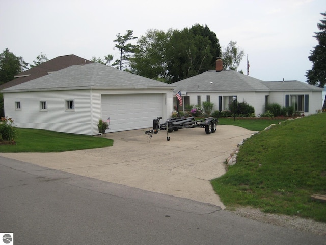 12225 SW Torch Lake Dr SW, Rapid City, MI 49676 - ranch-style home with an outdoor structure, a garage, a front lawn, and a chimney