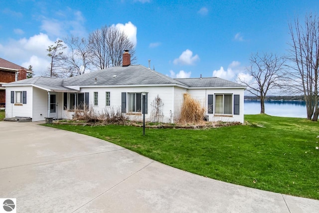 12225 SW Torch Lake Dr SW, Rapid City, MI 49676 - back of property featuring a yard, a water view, and a chimney