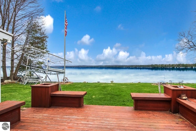 12225 SW Torch Lake Dr SW, Rapid City, MI 49676 - wooden deck featuring a water view and a lawn