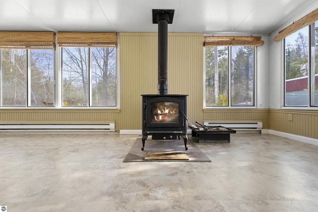 8481 E Houghton Lake Rd, Merritt, MI 49667 - detailed view of a wood stove, a baseboard radiator, and concrete floors