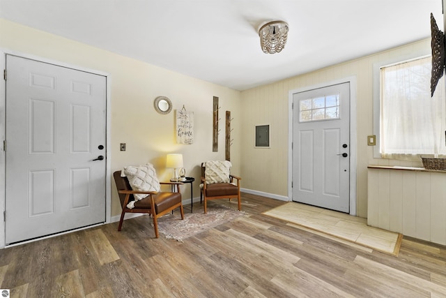 8481 E Houghton Lake Rd, Merritt, MI 49667 - foyer featuring electric panel, wood finished floors, and baseboards