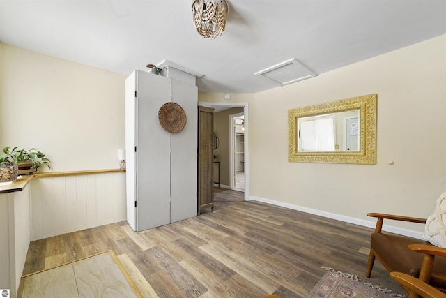 8481 E Houghton Lake Rd, Merritt, MI 49667 - sitting room featuring attic access, wood finished floors, and wainscoting