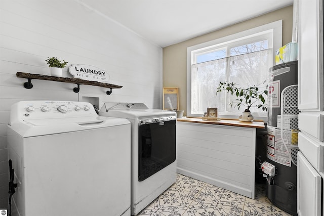 8481 E Houghton Lake Rd, Merritt, MI 49667 - laundry area with washing machine and dryer, water heater, and light tile patterned floors