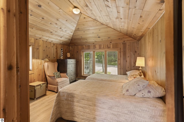 bedroom with wooden ceiling, vaulted ceiling, wooden walls, and wood finished floors