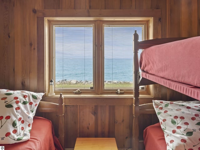 bedroom with wood walls