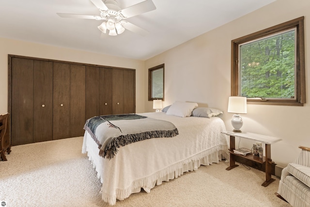 bedroom featuring light colored carpet and ceiling fan