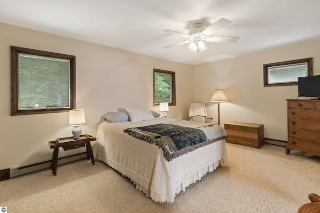 bedroom featuring light colored carpet, a baseboard radiator, and a ceiling fan