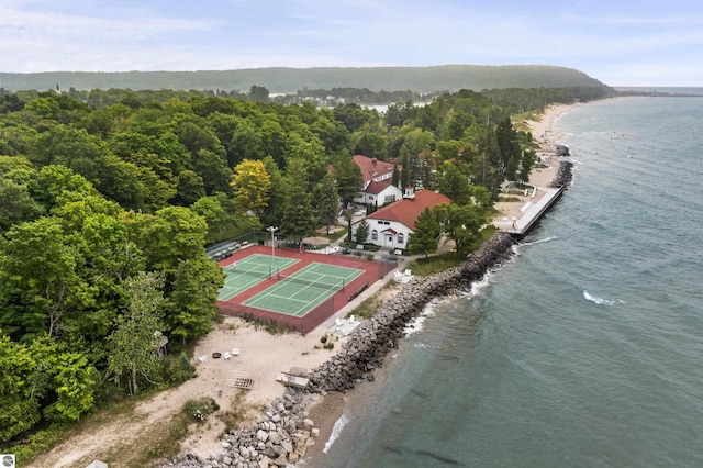 aerial view of a nearby body of water and a heavily wooded area