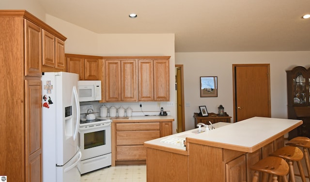kitchen with white appliances, a sink, light floors, light countertops, and recessed lighting