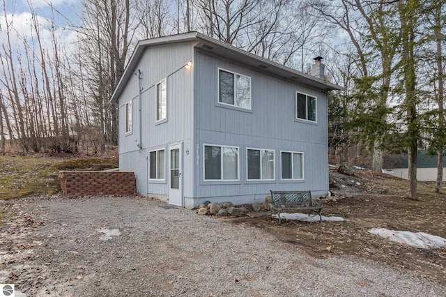 view of property exterior featuring a chimney