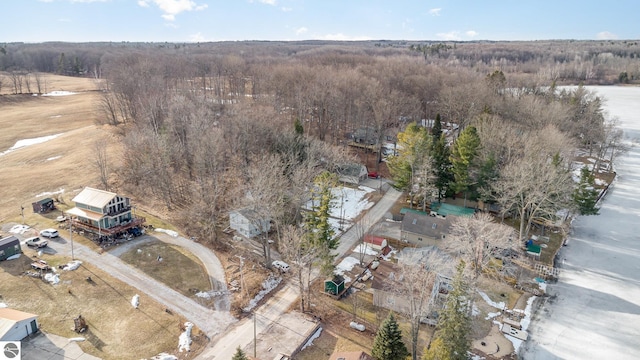 aerial view of property and surrounding area with a forest