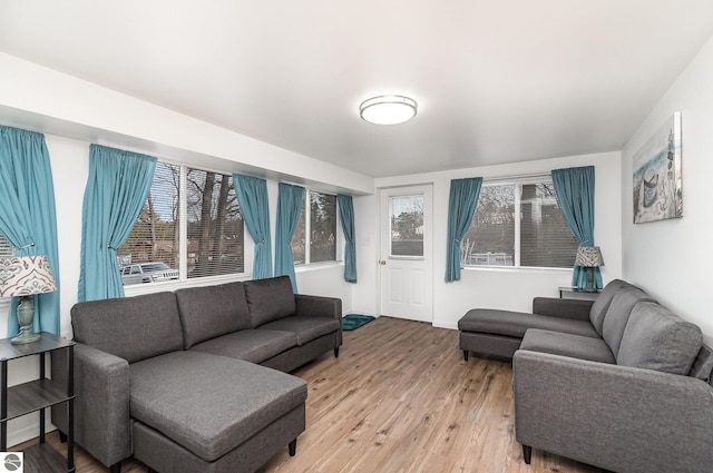 living area with light wood-style floors and baseboards