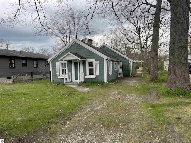 view of front of home with a chimney and covered porch