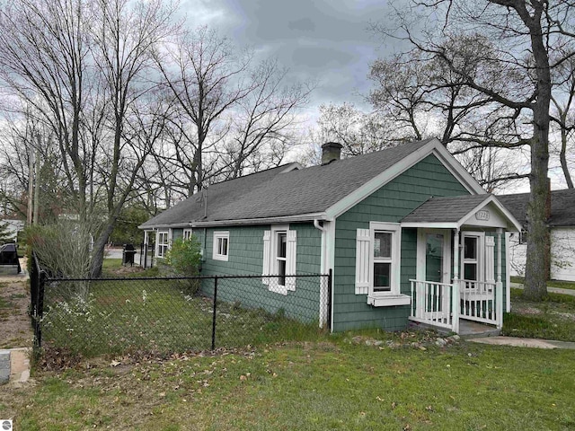 view of front of home with a chimney and roof with shingles