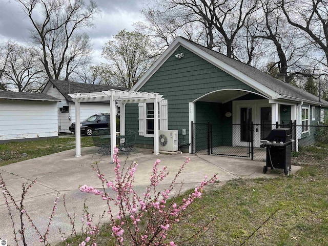 rear view of house featuring a gate, a cooling unit, a pergola, and fence