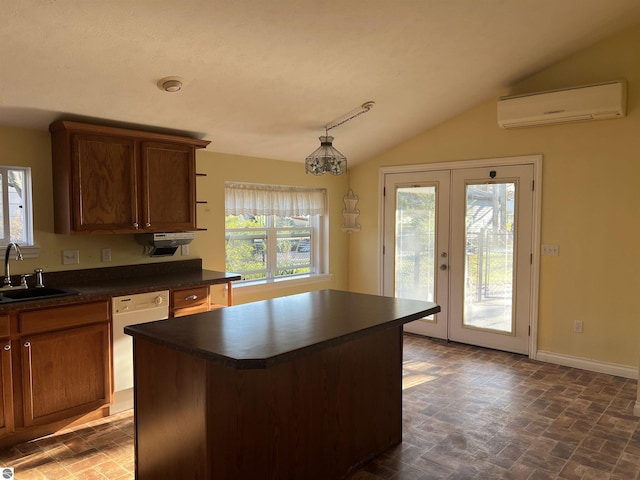 kitchen featuring a sink, a wall unit AC, dark countertops, baseboards, and french doors