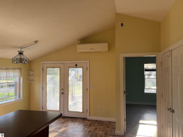 entryway featuring a wall mounted air conditioner, vaulted ceiling, baseboards, and french doors