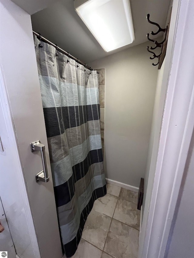 15831 SE M 72, Grayling, MI 49738 - bathroom with marble finish floors and a shower with curtain