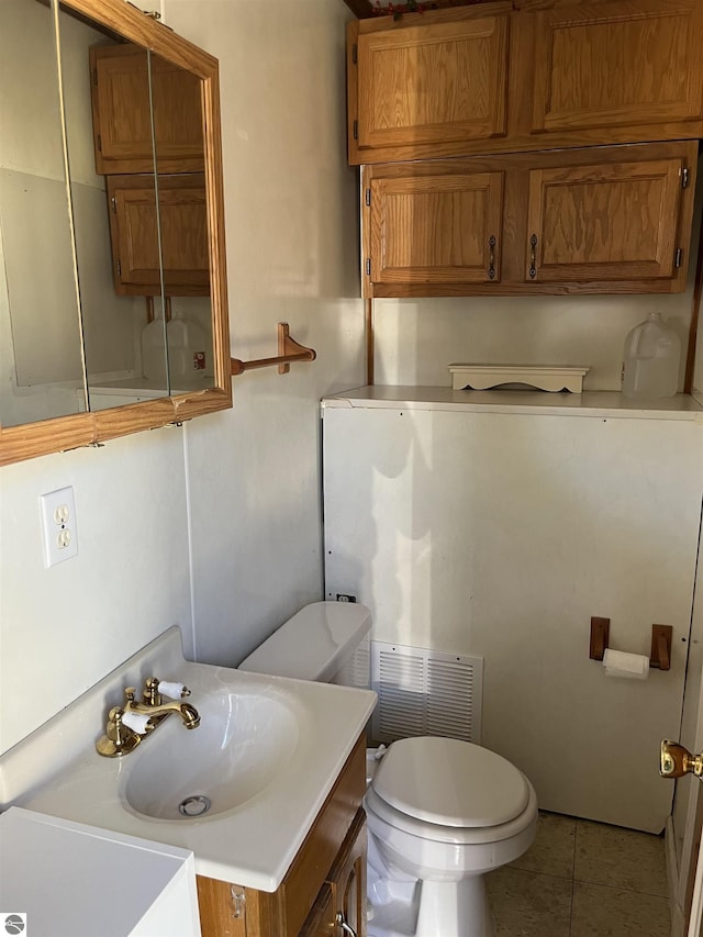15831 SE M 72, Grayling, MI 49738 - bathroom featuring toilet, tile patterned flooring, and vanity