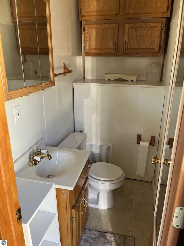 15831 SE M 72, Grayling, MI 49738 - bathroom with toilet, tile patterned flooring, and vanity