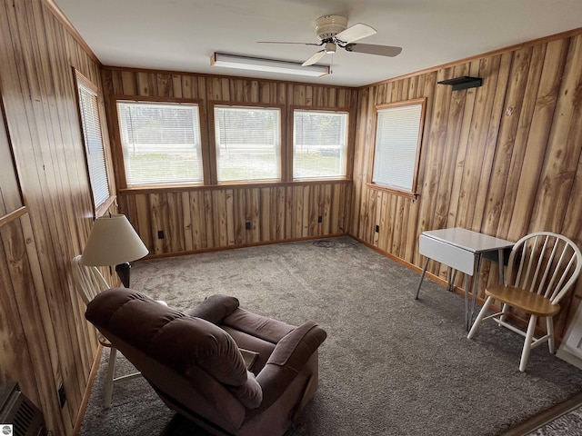 15831 SE M 72, Grayling, MI 49738 - sitting room featuring healthy amount of natural light, wood walls, a ceiling fan, and carpet
