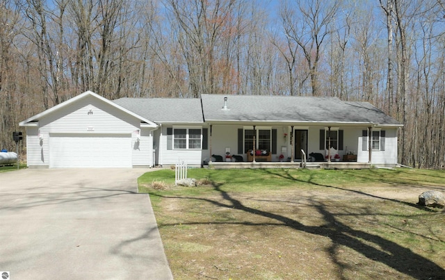 ranch-style home featuring covered porch, an attached garage, concrete driveway, a front yard, and roof with shingles