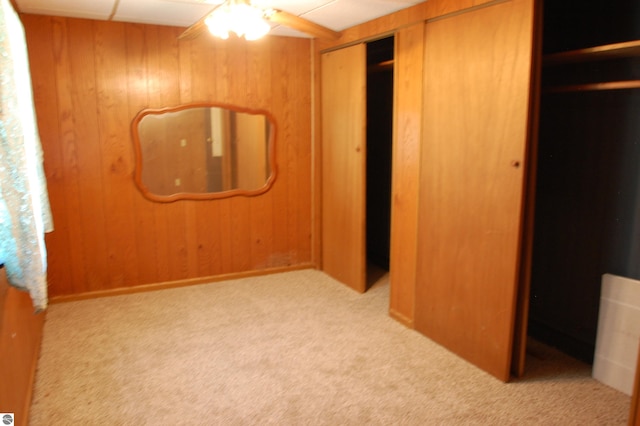 2993 N Ogemaw Trl, West Branch, MI 48661 - unfurnished bedroom featuring carpet and wooden walls