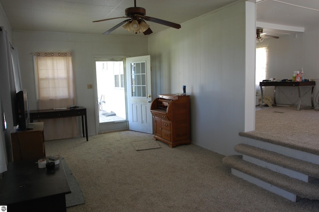 2993 N Ogemaw Trl, West Branch, MI 48661 - living room with ceiling fan, carpet floors, and stairway