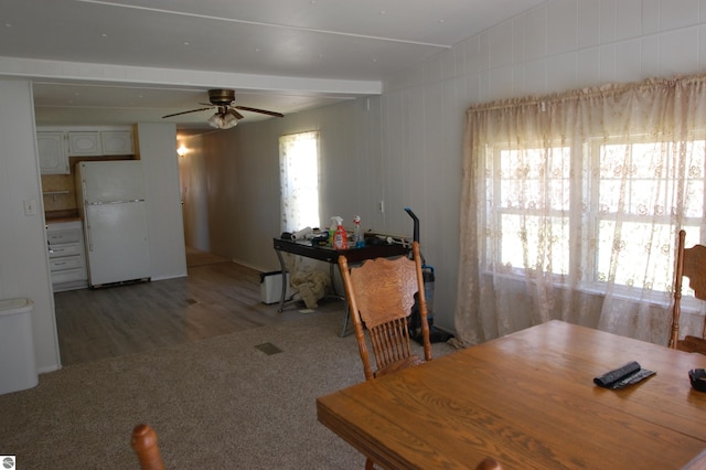 2993 N Ogemaw Trl, West Branch, MI 48661 - dining room featuring a ceiling fan, light colored carpet, and light wood-style flooring