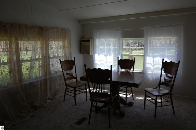 2993 N Ogemaw Trl, West Branch, MI 48661 - carpeted dining room with a wall mounted air conditioner and vaulted ceiling