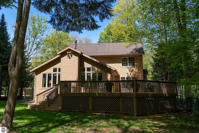 back of house with a wooden deck and a yard