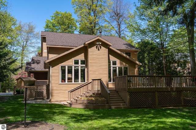 back of property featuring stairs, a deck, a yard, and a shingled roof