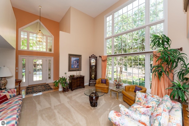 living room with a high ceiling, carpet flooring, and baseboards