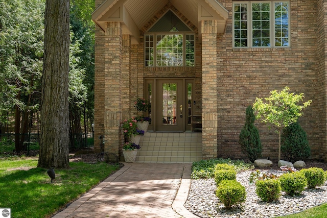 property entrance with brick siding and driveway