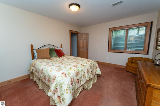 carpeted bedroom featuring baseboards