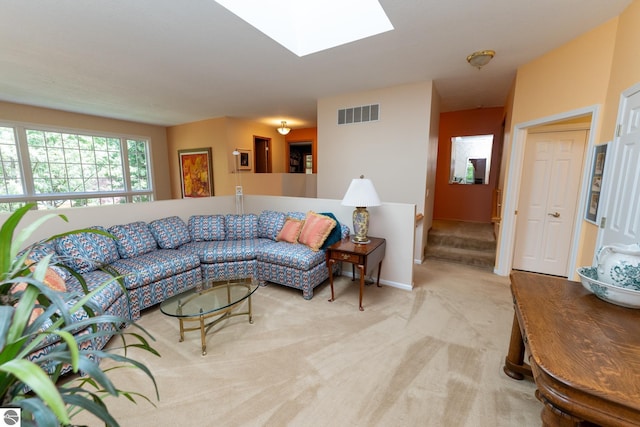 carpeted living area with a skylight