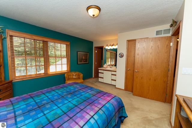 carpeted bedroom featuring a textured ceiling and a closet